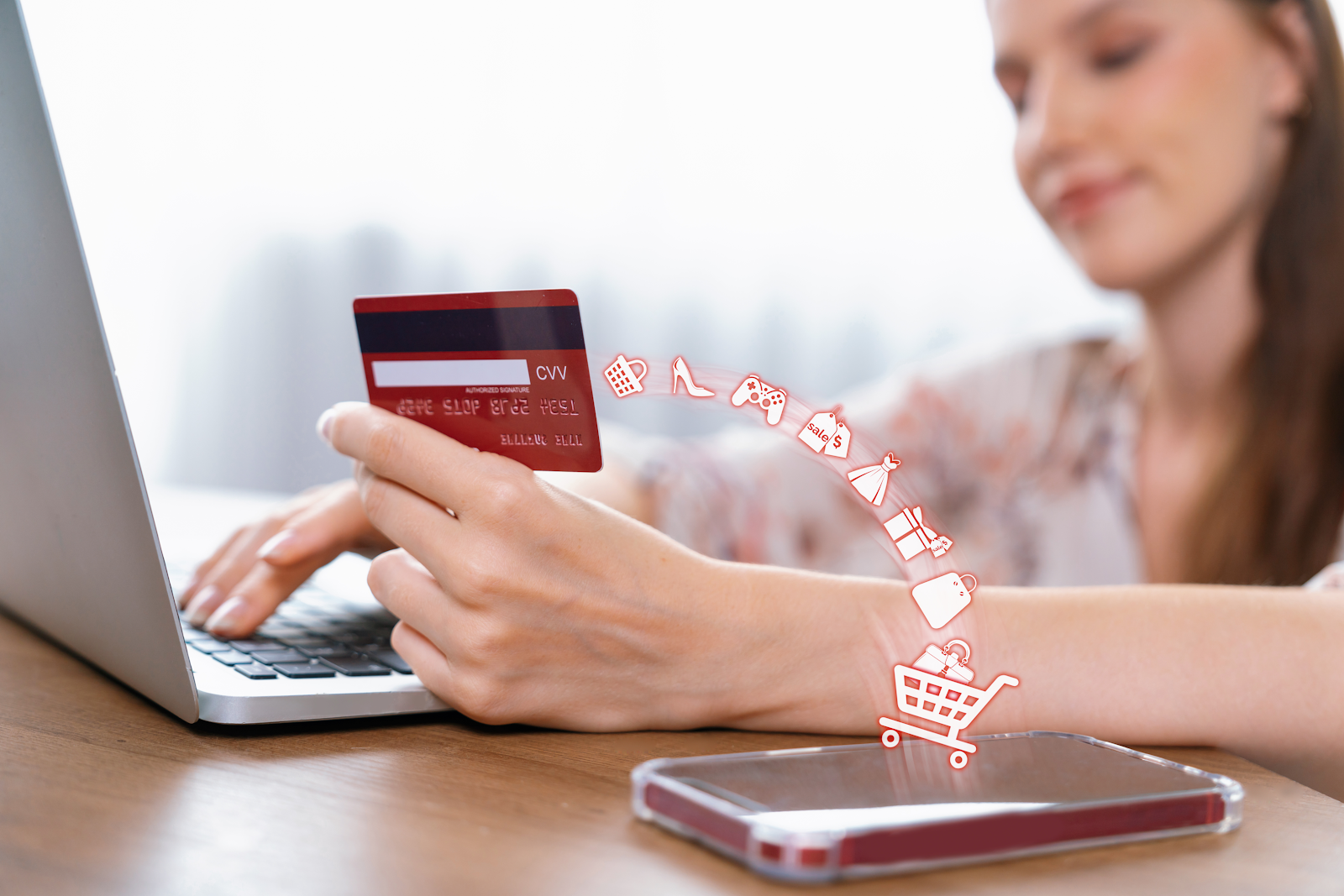 woman doing online shopping with her phone and laptop