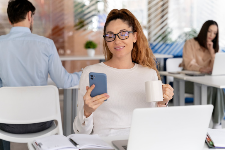 Woman using her phone in an office