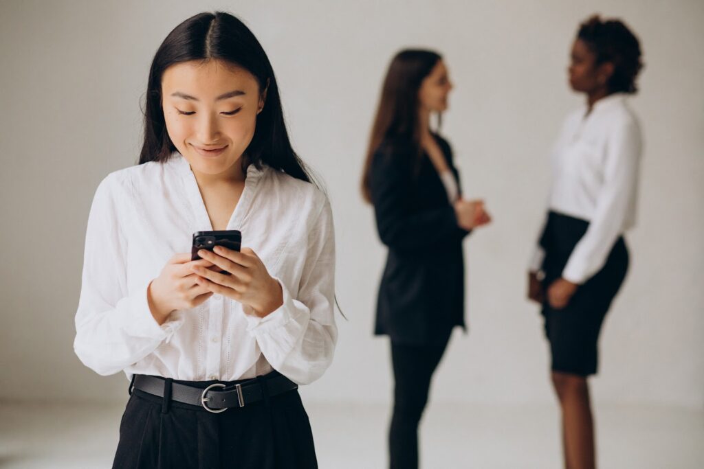business woman using a phone and smiling
