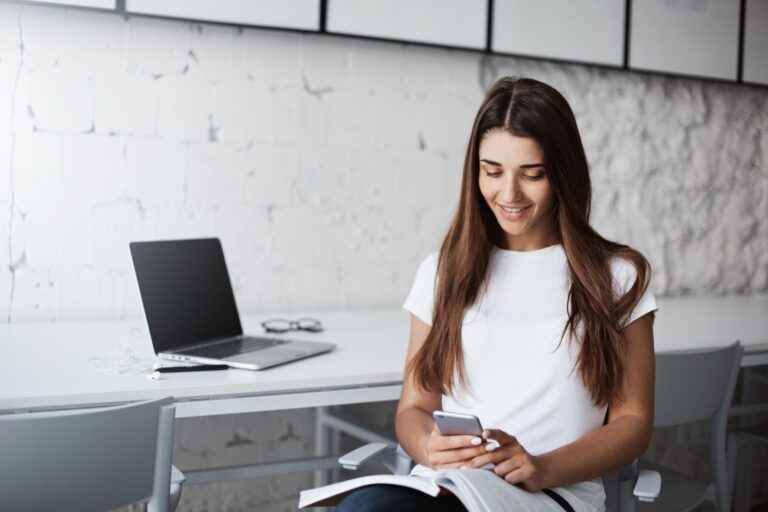 A woman sitting while using her phone