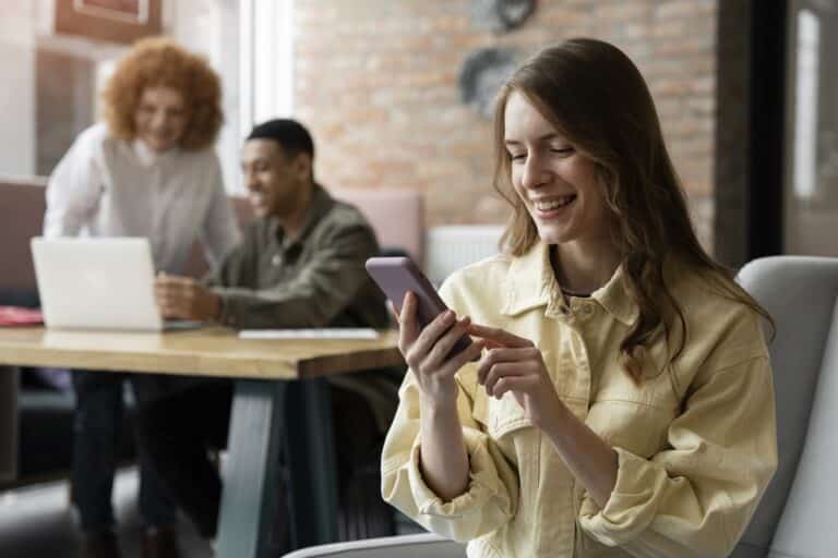 A woman reads a promotional SMS in an office