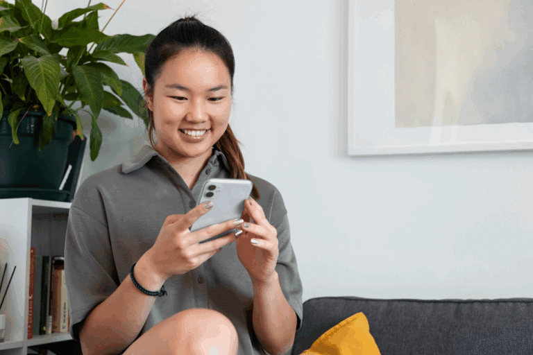 Smiling woman reading an SMS