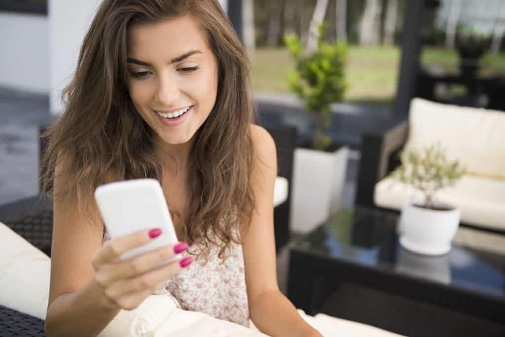 Young woman reading an SMS message