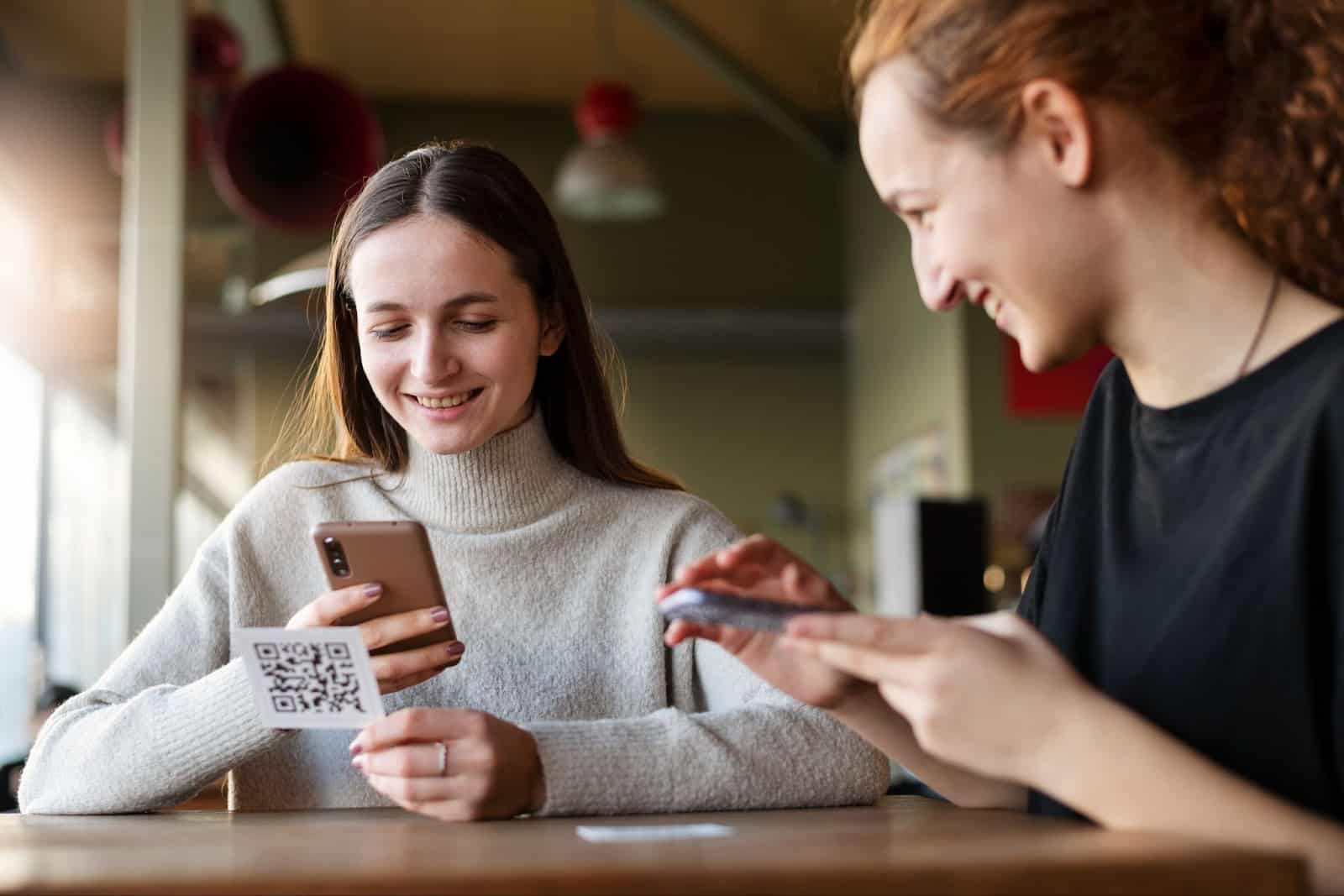 Two woman scanning a QR Code