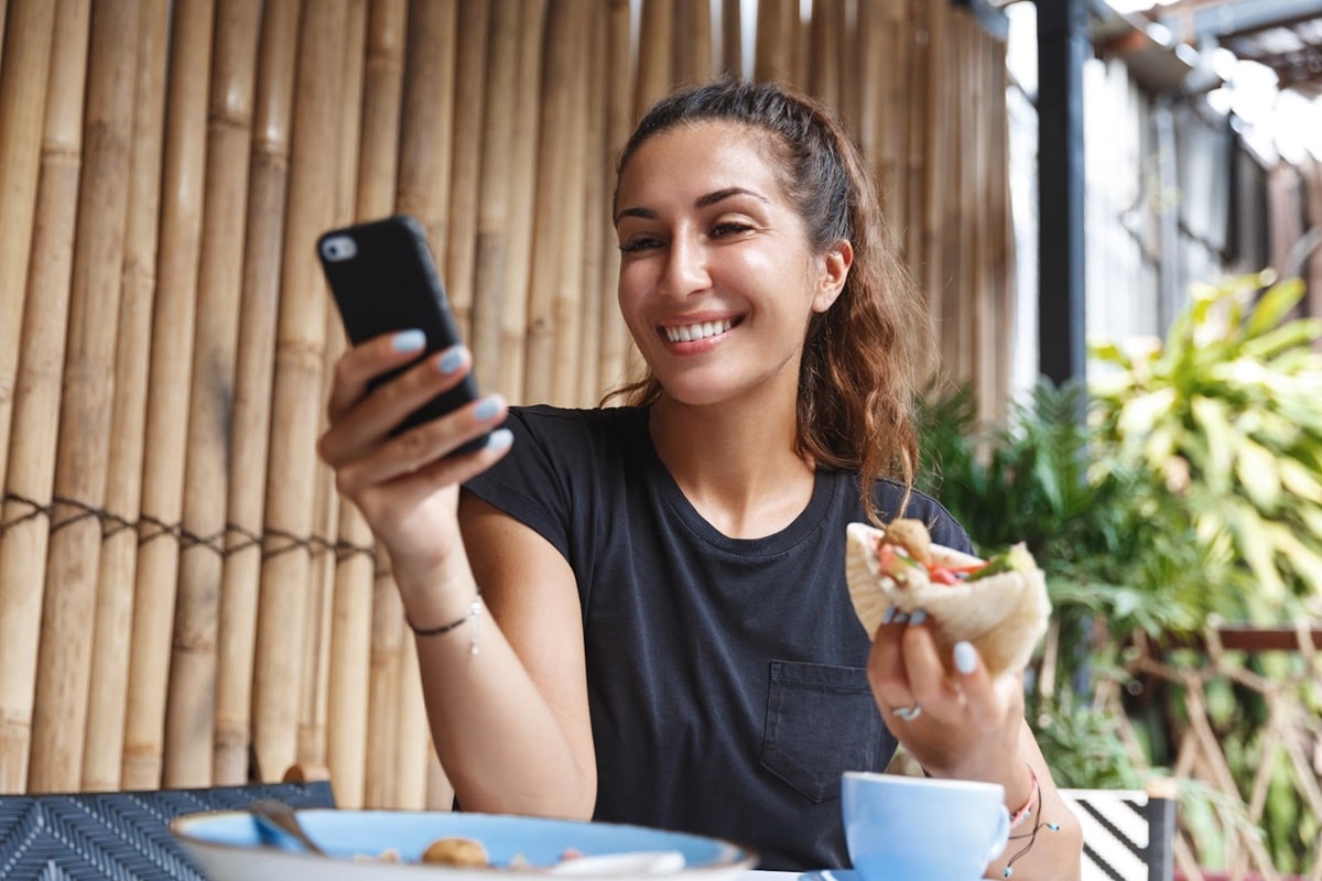 Woman reading an SMS in a restaurant