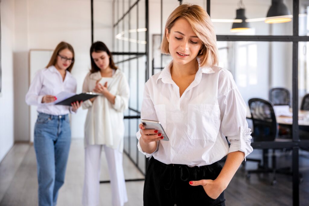 A girl using a phone inside the Office